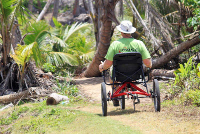 Riding a HASE Bikes TRIGO recumbent trike on a Puerto Rico beach trail.