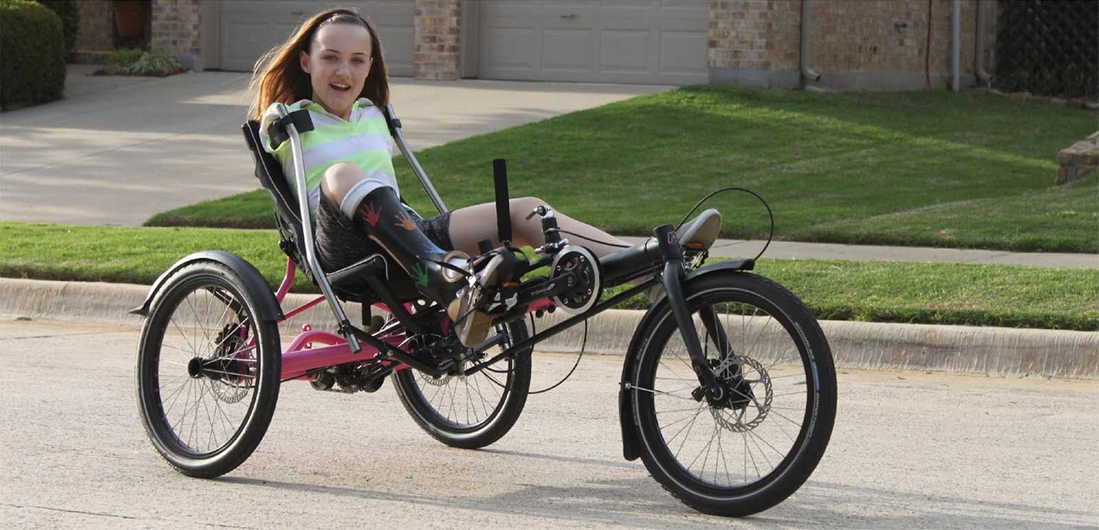 Girl riding an adaptive recumbent trike