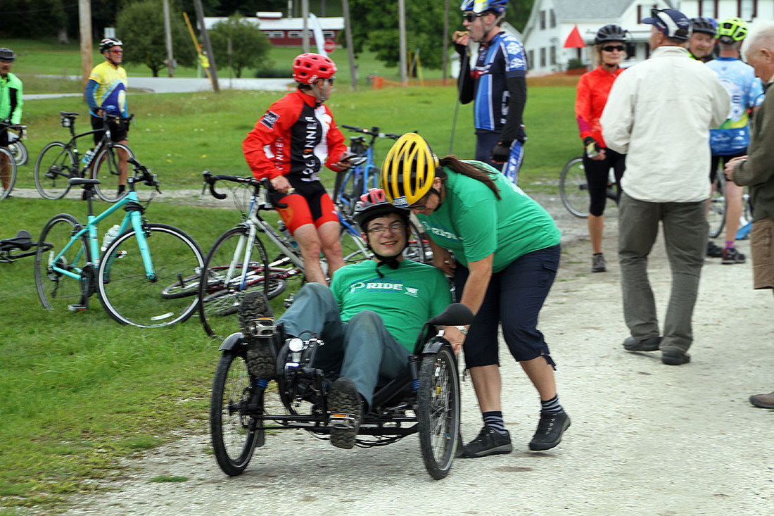 Anja Wrede of RAD-Innovations helping a rider on a tadpole recumbent trike