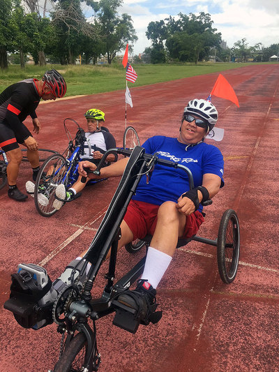 Marguretia Hernandez rides a BerkelBike combination handcycle and recumbent trike on the track. 