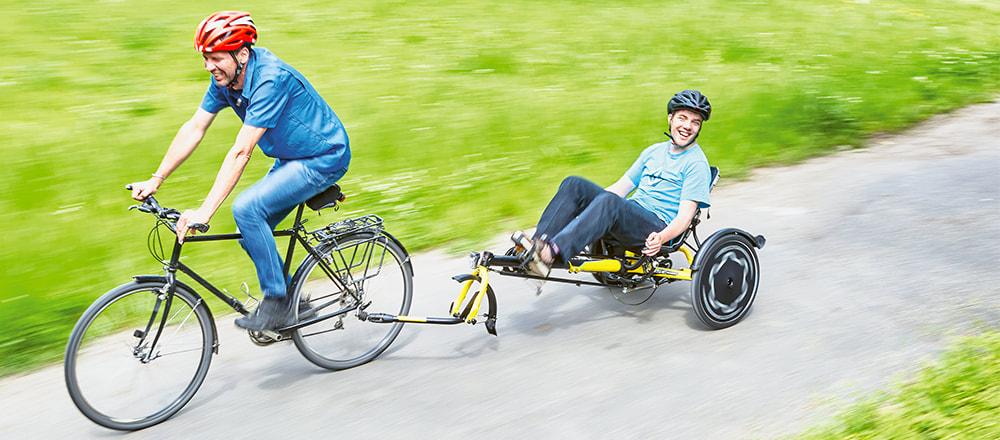 A Hase Trets trike attached as a tandem trailer behind a bicycle