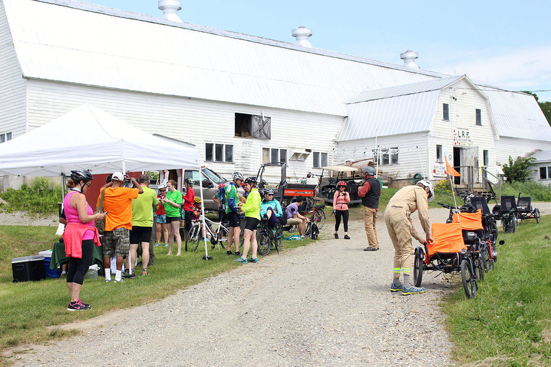 Tour de Farms stop at a barn with tents set up for riders